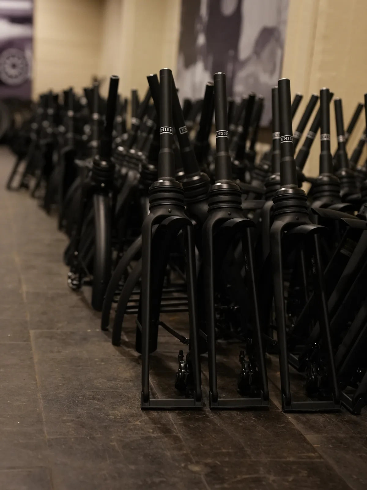 Rows of black frames and forks on the floor